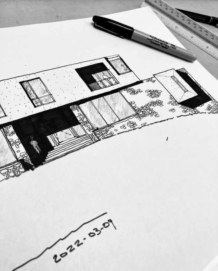 Sketch of a modern house, drawn with black ink on paper, on a desk with a Sharpie marker, a ruler, and a pen, dated 2022-03-09.