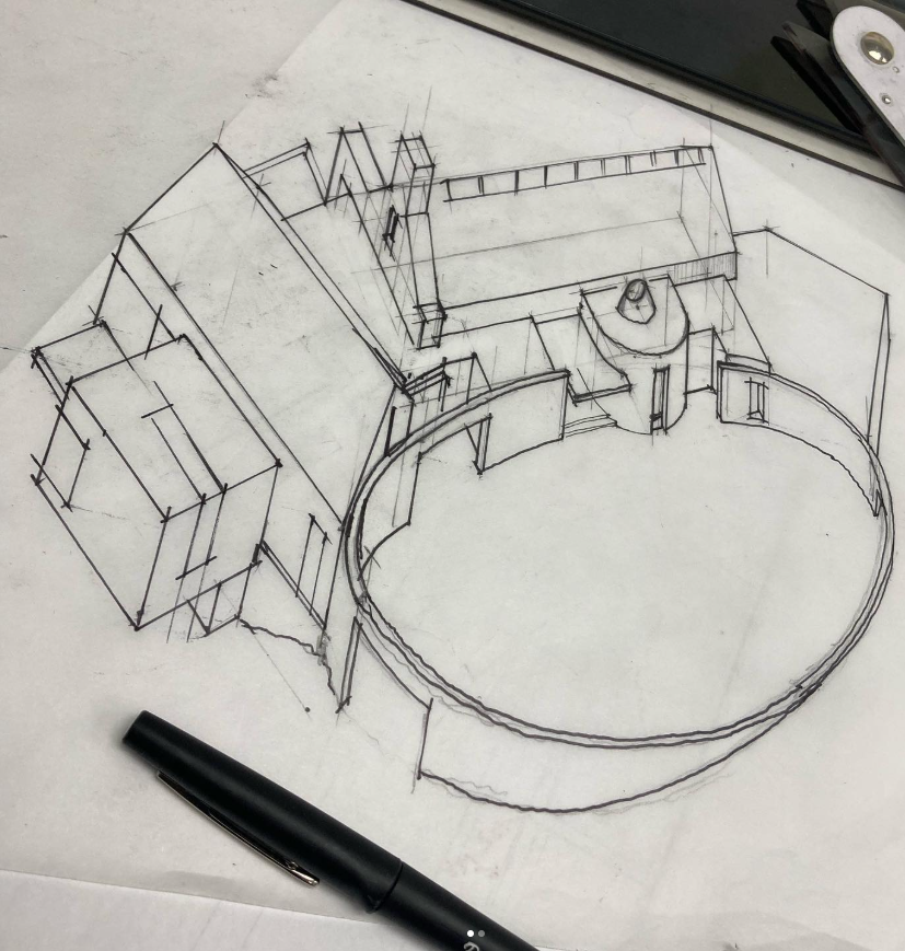 Architectural sketch of a modern house with a circular feature, drawn on paper with a black pen nearby.