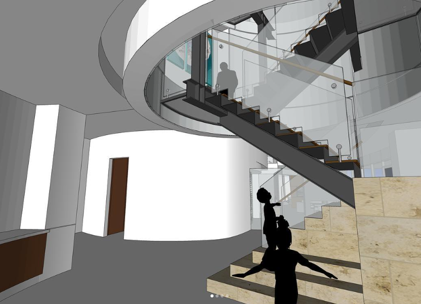 Interior view of a modern building with a spiral staircase, glass railings, and two silhouetted figures, one ascending the stairs and another standing at the bottom.