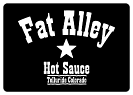 A black sign with white text that reads "Fat Alley Hot Sauce Telluride Colorado" and features a star in the center.