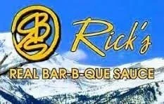 Sign for Rick's Real Bar-B-Que Sauce with snowy mountain background