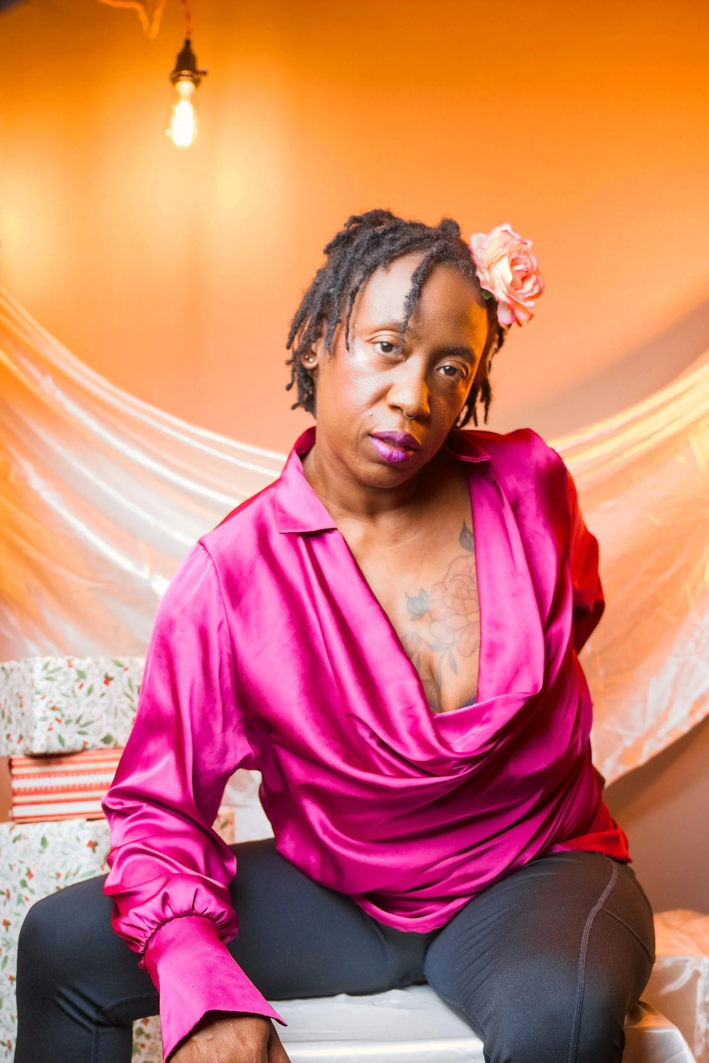 Woman in bright pink top confidently facing camera.