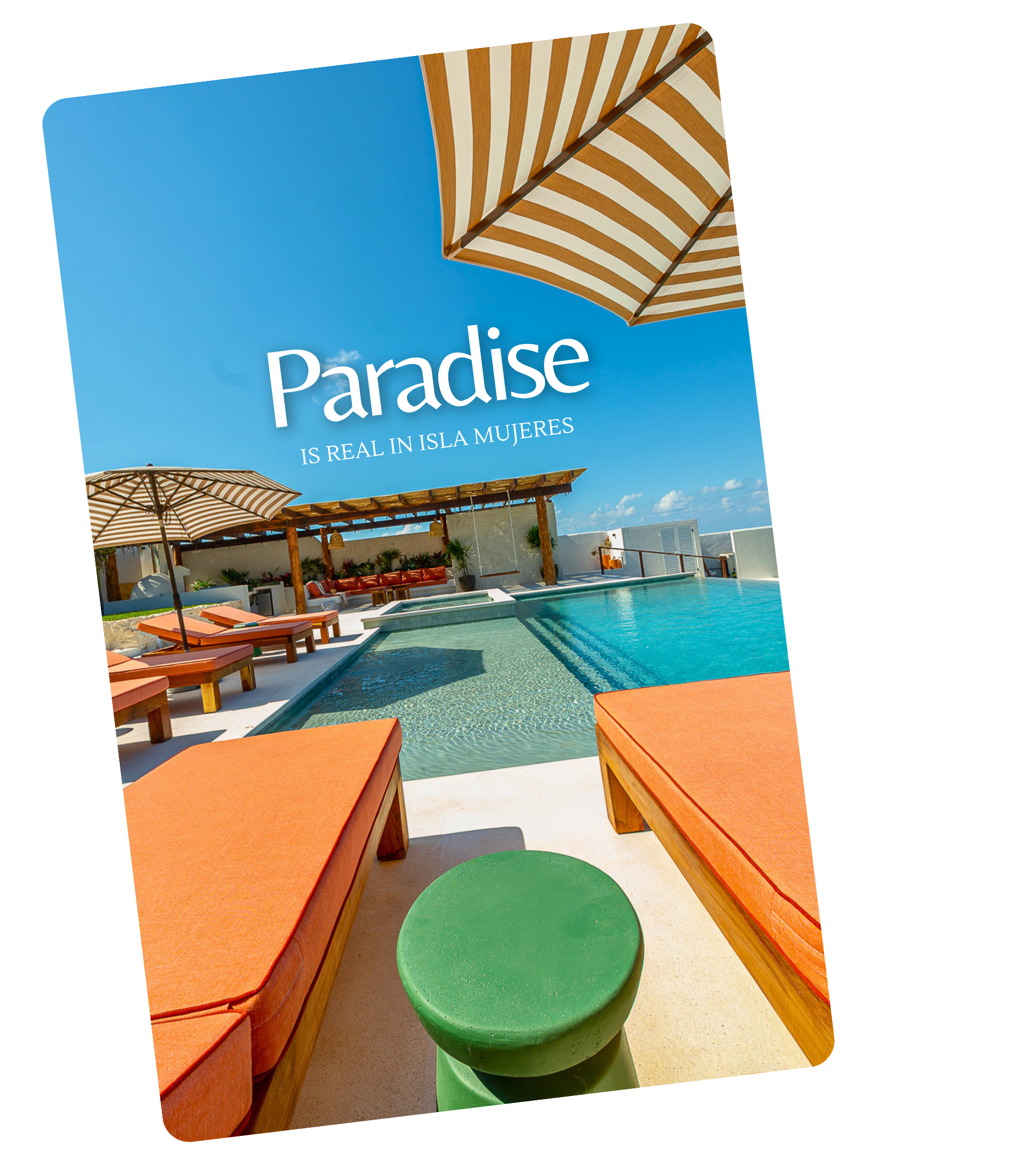 A swimming pool area with lounge chairs, umbrellas, and colorful furniture on a bright sunny day.