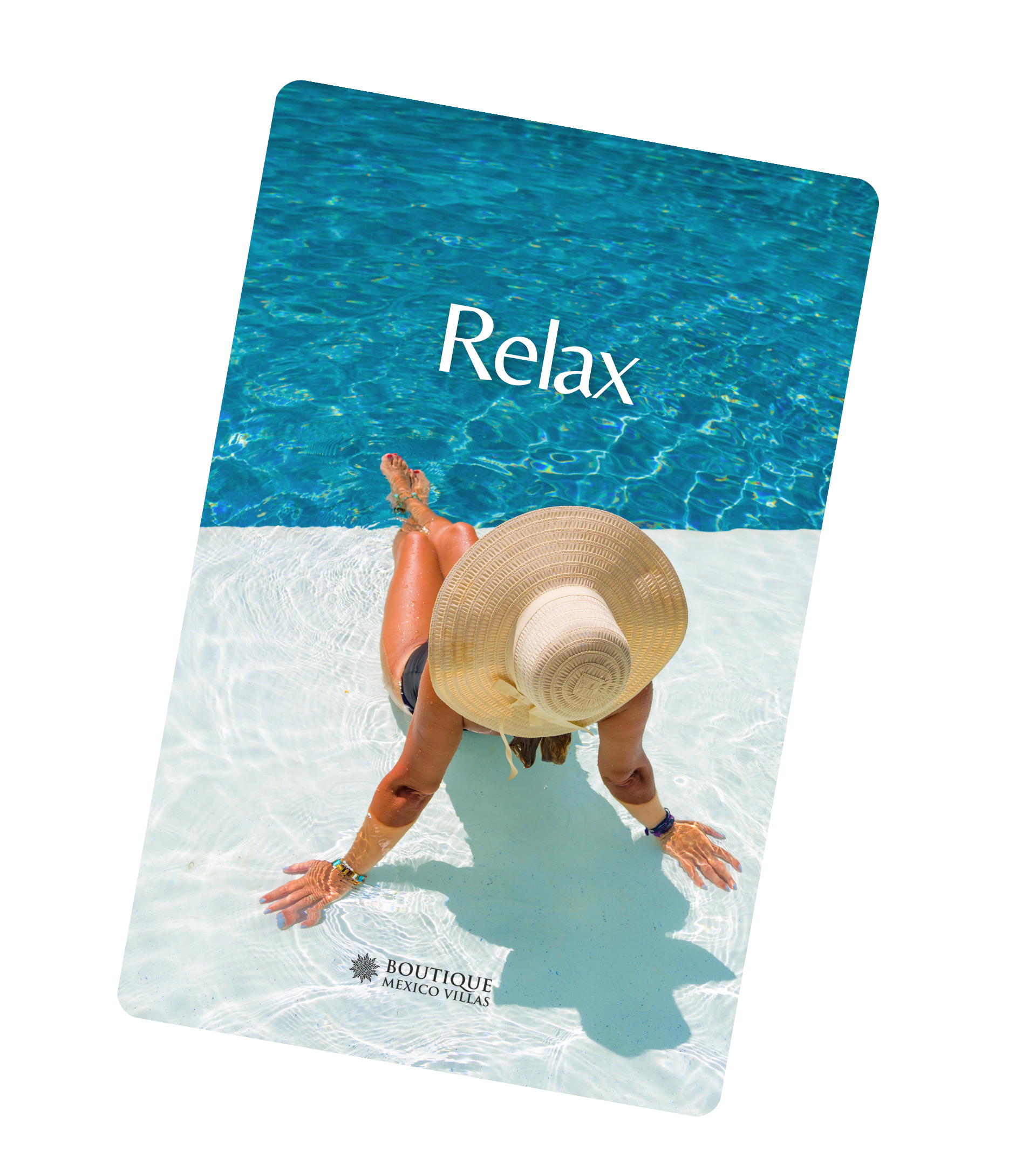 A woman relaxing by the swimming pool with her feet in the water, wearing a wide-brimmed sun hat and black swimsuit, with the words 'Relax' and a logo for Boutique Mexico Villas visible on the poolside mat.