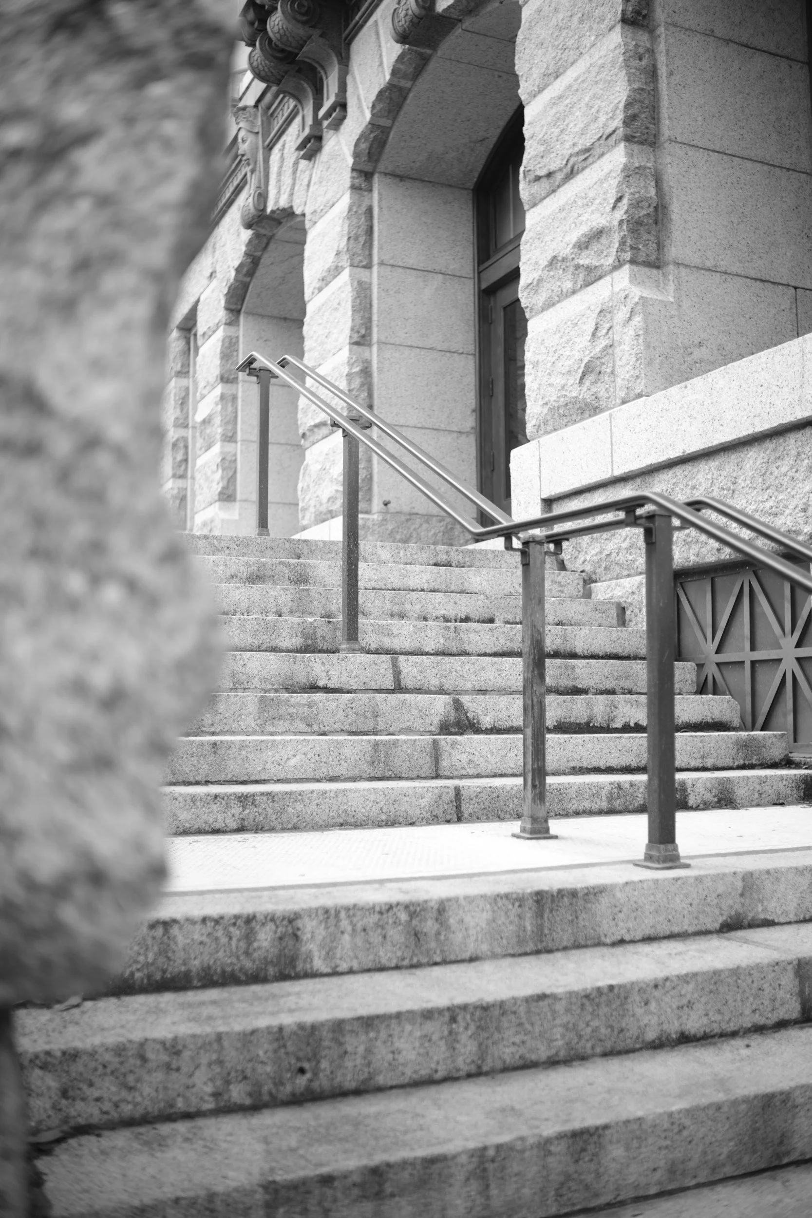 Courthouse steps seen through the stonework.