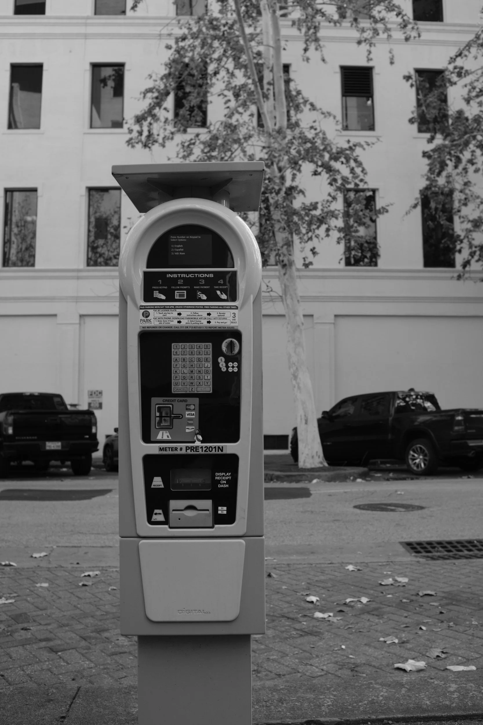 The parking pay station — downtown's smallest ATM of regret.