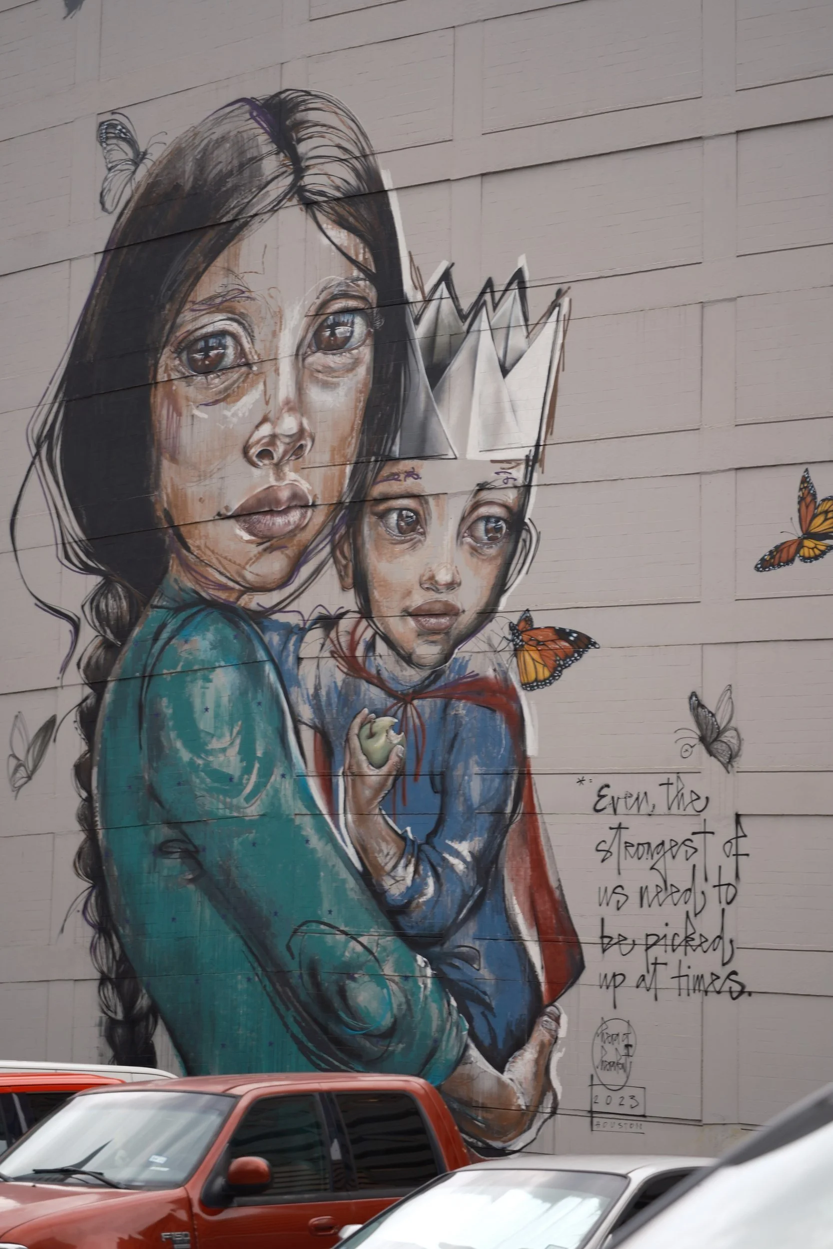 A mural of a mother holding her crowned child.