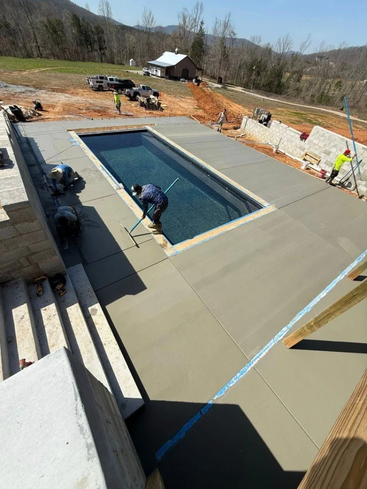 Man Smoothing Concrete by pool