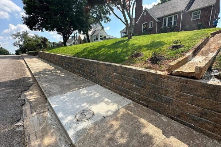 Concrete block retaining wall installation on sloped driveway in Mcminnville, TN.