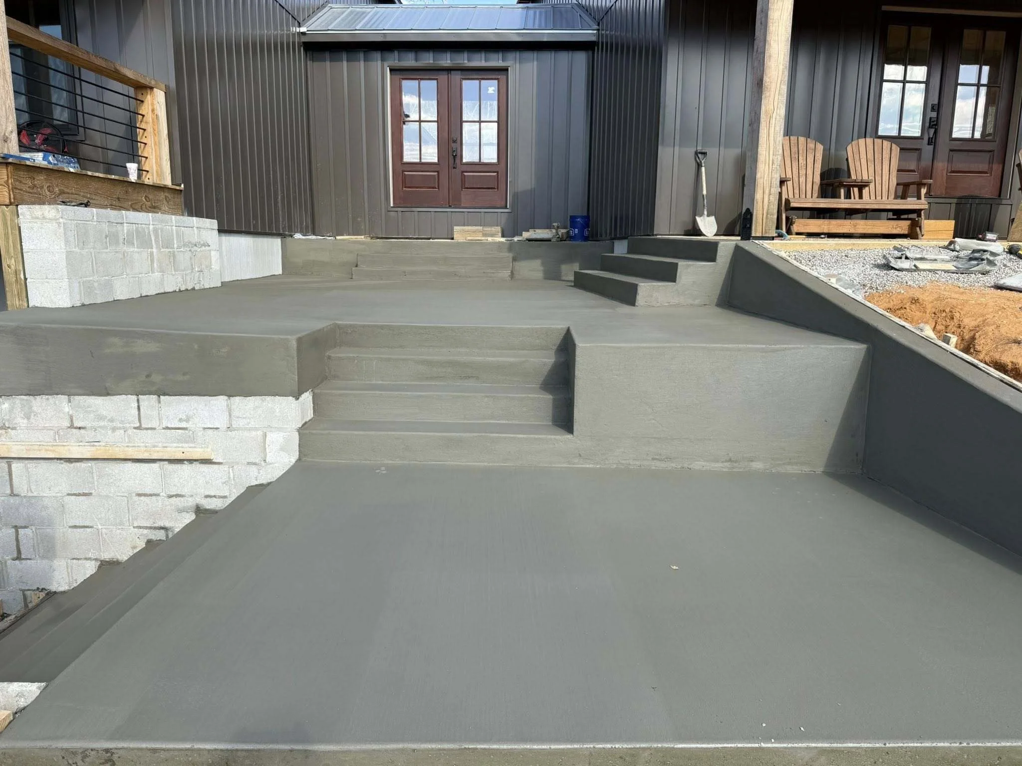 Concrete stairs Manchester TN completed with multi-tier steps, patios, and retaining walls at residential property