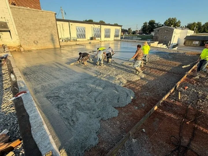 Gillespie Concrete crew placing and leveling fresh concrete for an 8,000 square foot commercial parking lot in downtown McMinnville TN
