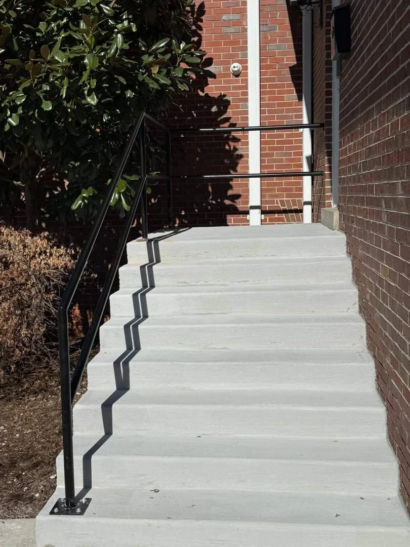 New concrete stairs with black handrails installed at Central Church of Christ in McMinnville, TN