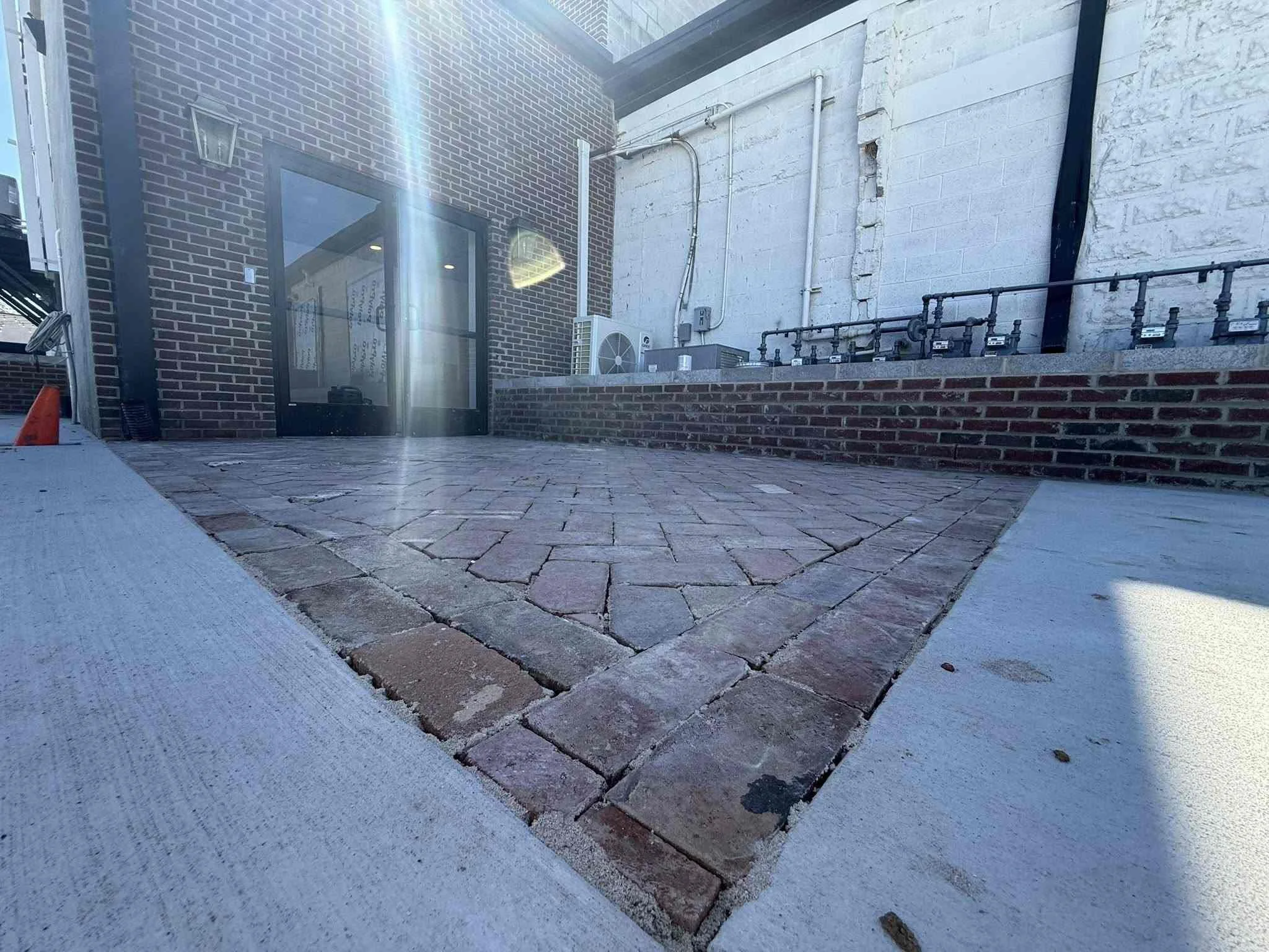 Commercial hardscape project with brick paver walkway and retaining wall in downtown McMinnville