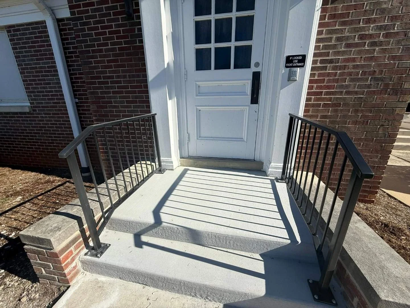 Concrete entry landing and handrails at front door of Central Church of Christ in McMinnville, TN