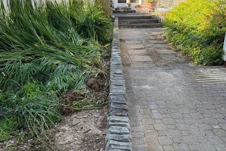 Retaining wall beside home walkway with landscaping in Manchester, TN.