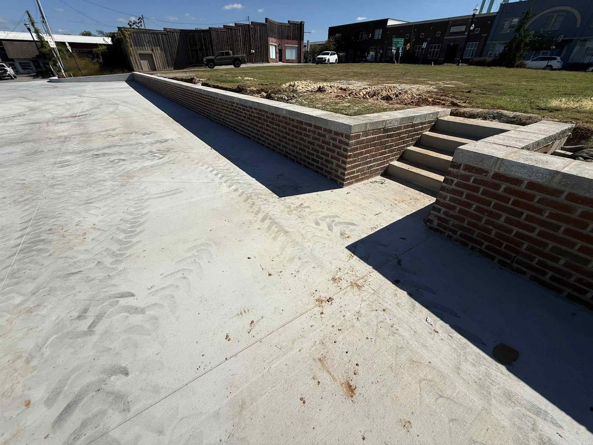 Concrete sidewalk and brick retaining wall installation for Main Street Center McMinnville TN