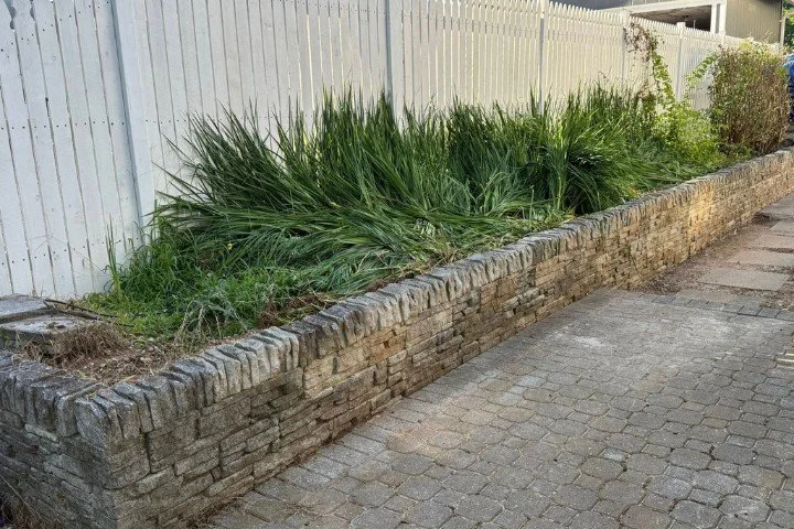 Stone retaining wall and paver walkway hardscape project in Manchester, TN residential yard