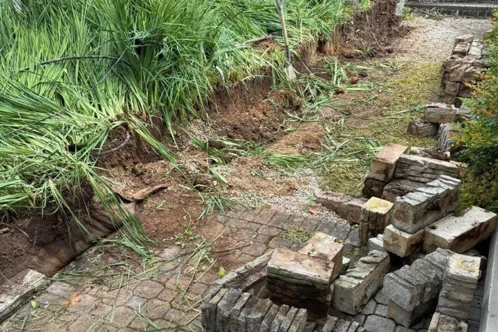 Crew rebuilding retaining wall and preparing foundation near home in Manchester, TN.