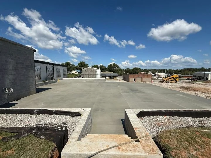 Completed commercial concrete parking lot with retaining walls and stairs in downtown McMinnville TN