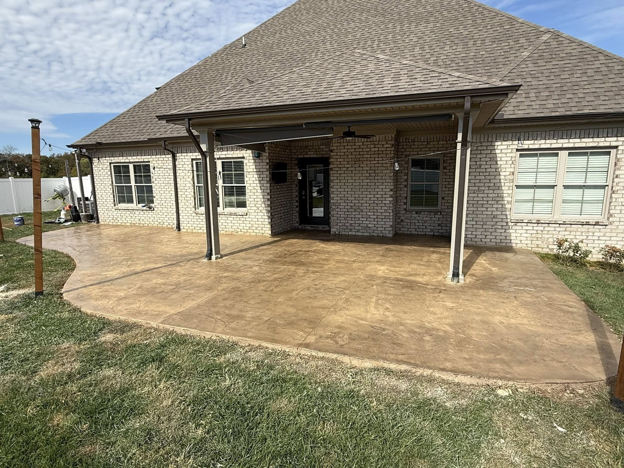 Stamped concrete patio overlay with stone pattern finish as part of residential hardscape project