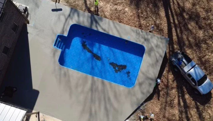 Blue pool with new concrete patio