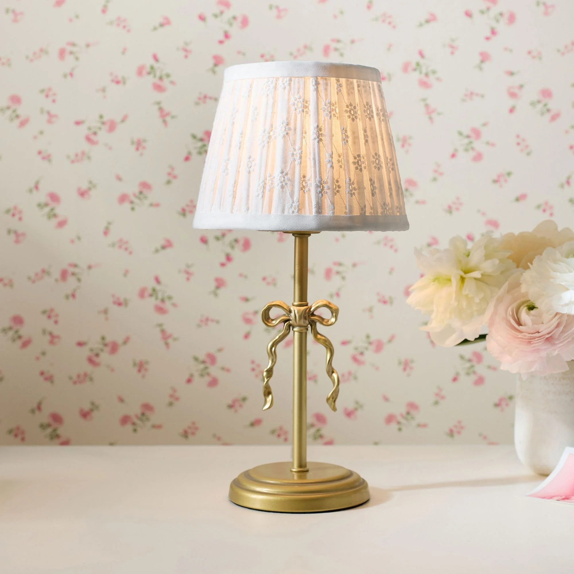 Brass table lamp with a pleated shade selected for the La Petite bedroom.