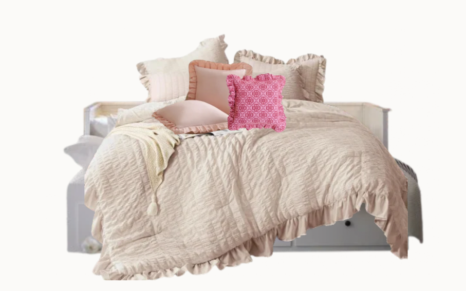 Cream children’s bedding with layered ruffles and blush pink accent pillows selected for the La Petite bedroom.