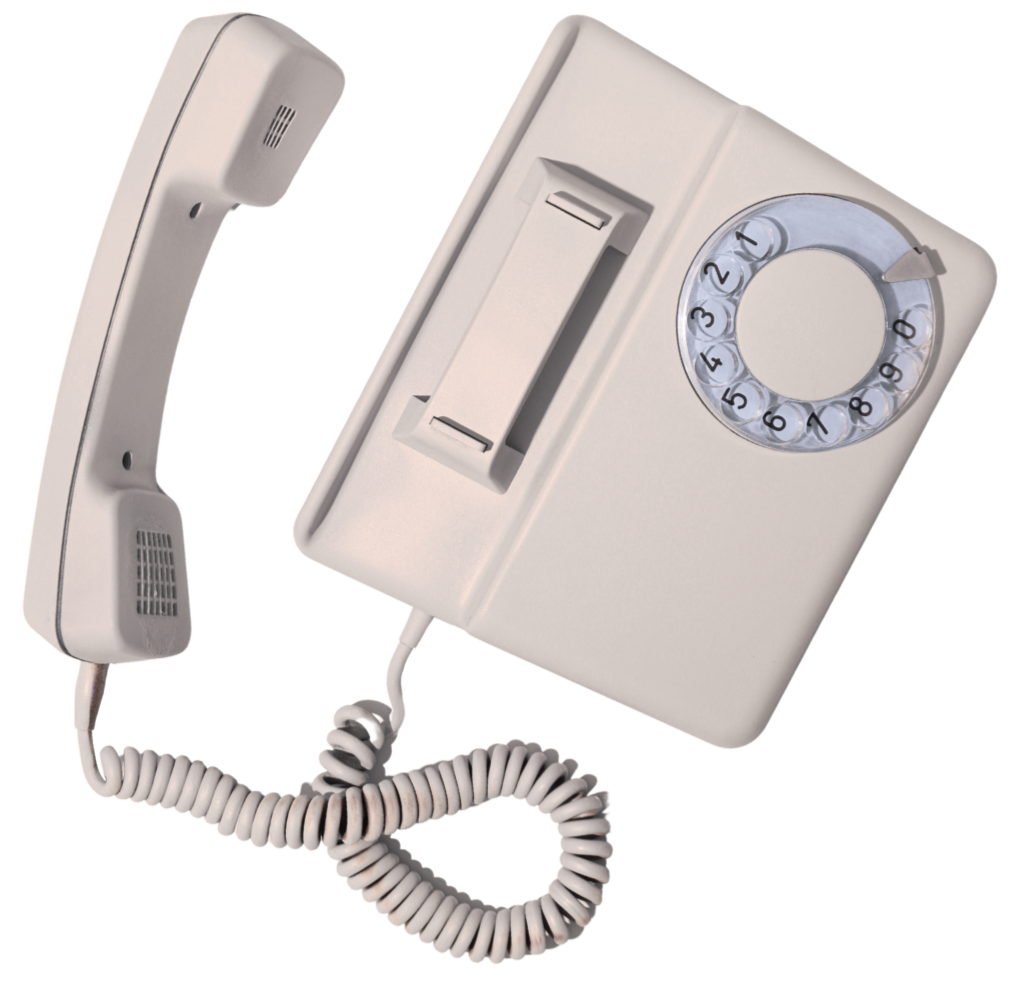 An intercom system with a vintage rotary dial phone and a wall-mounted section with a modern push-button and a rotary dial.