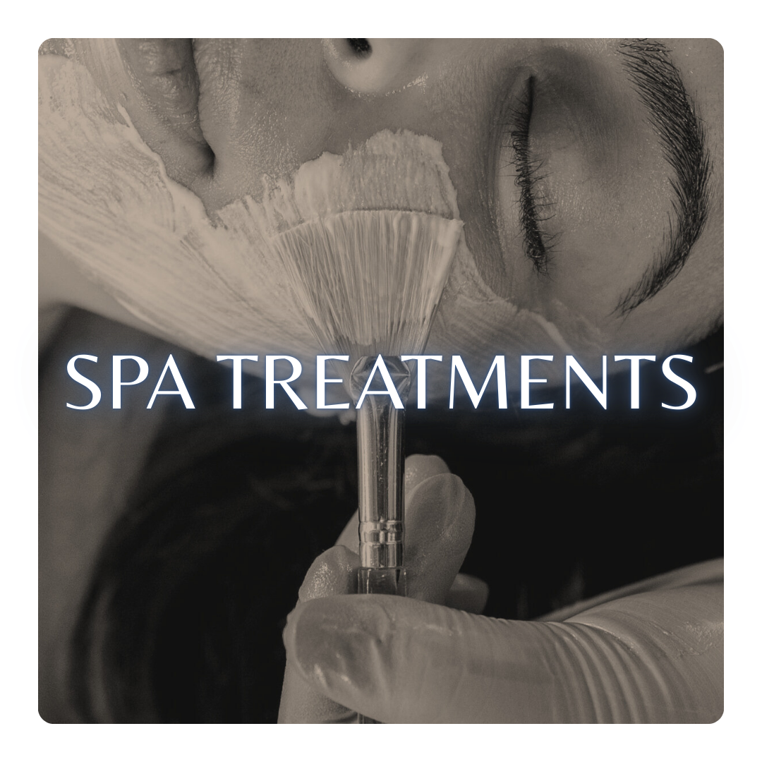 Close-up of a person receiving a spa treatment, with a brush and cream on their face, and the text 'Spa Treatments' overlayed.