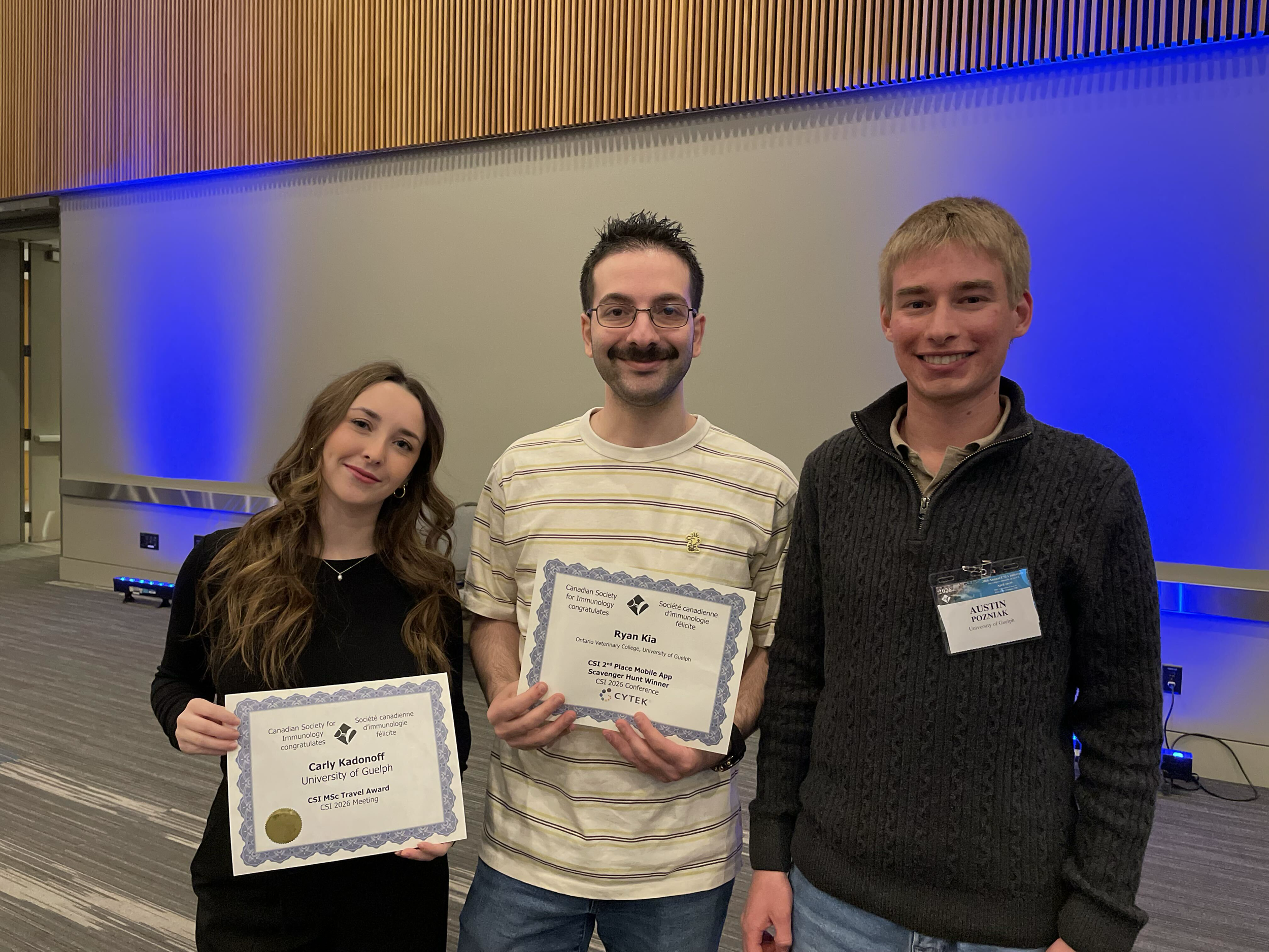 The lab at the Canadian Society for Immunology Annual Meeting, 2025, with Carly receiving her travel award
