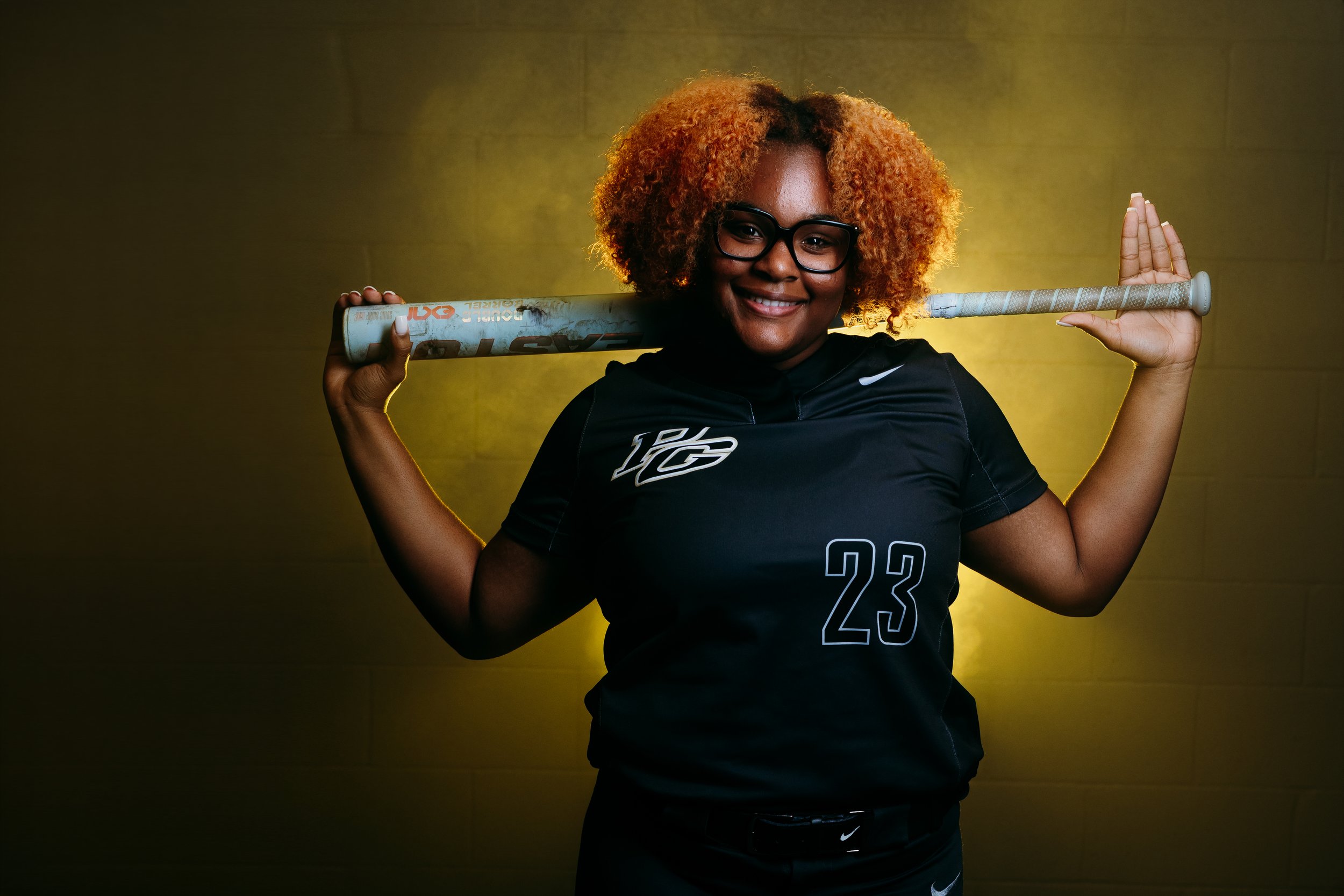 Softball high school athlete portrait taken during media day with custom lighting setup