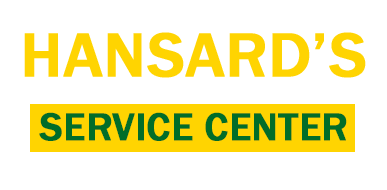 Sign for Hansard's Service Center with yellow and green text on a black background.