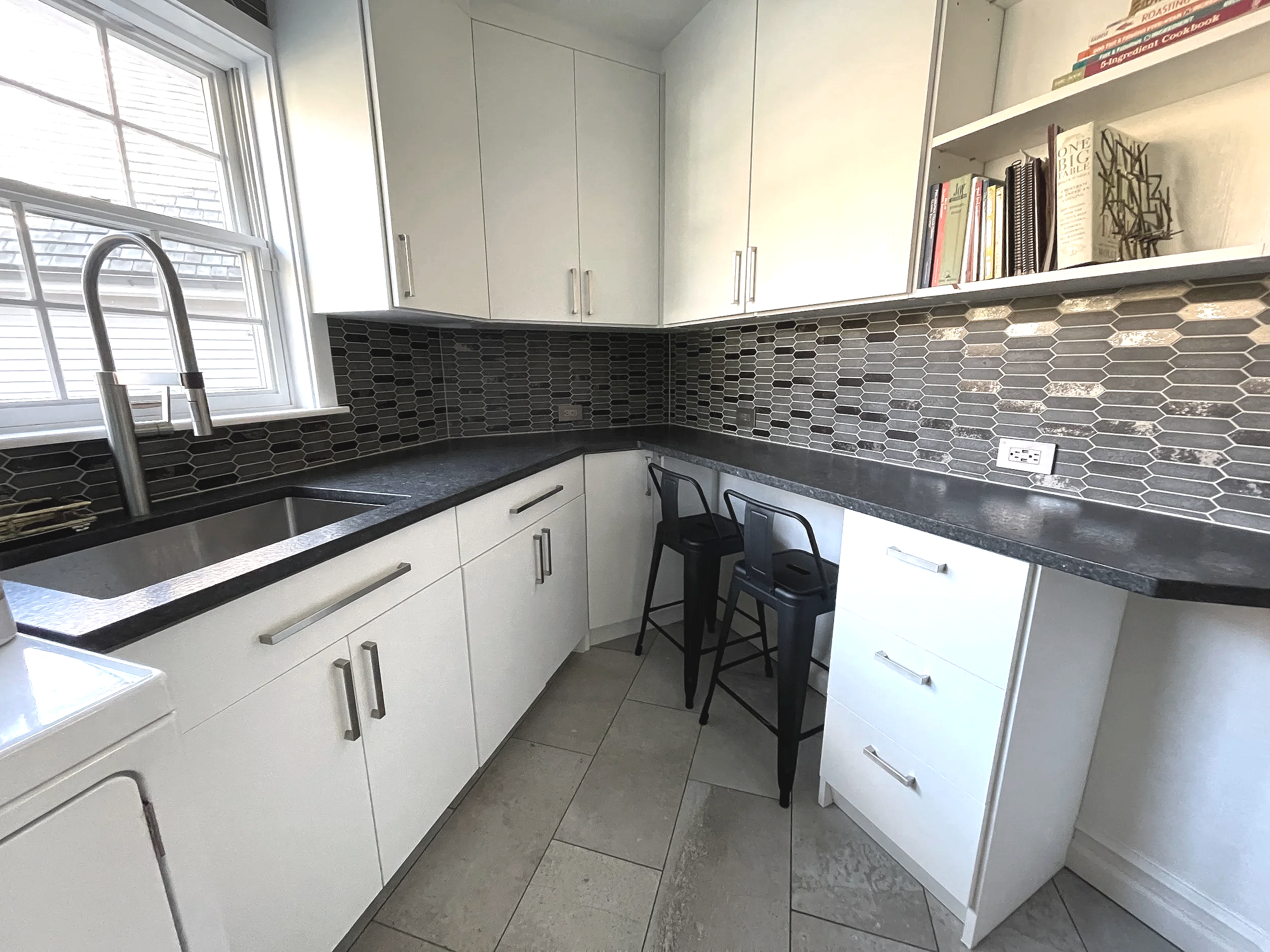 Laundry room featuring a bold dark metallic picket tile backsplash, designed and photographed by Sara Trotter / Chroma Maison Design.