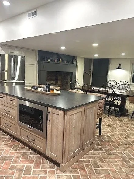 Farmhouse kitchen with Omega white oak island and Silestone Bohemian Flame quartz countertops.  Flooring is Inglenook tile in a herringbone pattern, designed and photographed by Sara Trotter / Chroma Maison Design.