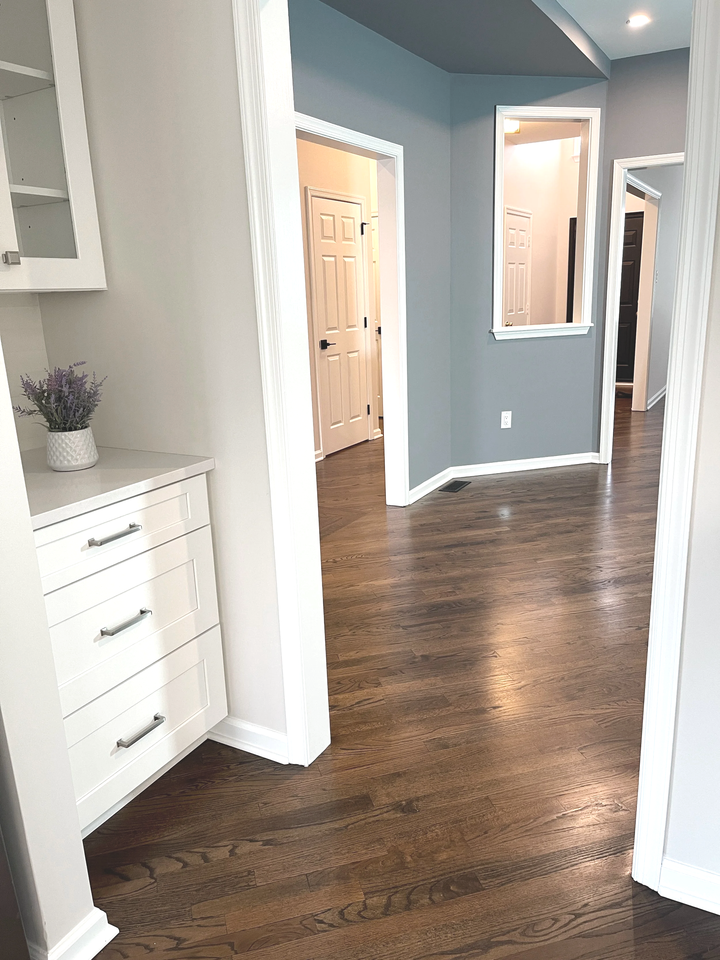 A creative way to incorporate color into an open floor plan.  Featuring a light bright kitchen into a more dramatic gray blue dining room area.  Designed by Sara Trotter / Chroma Maison Design.