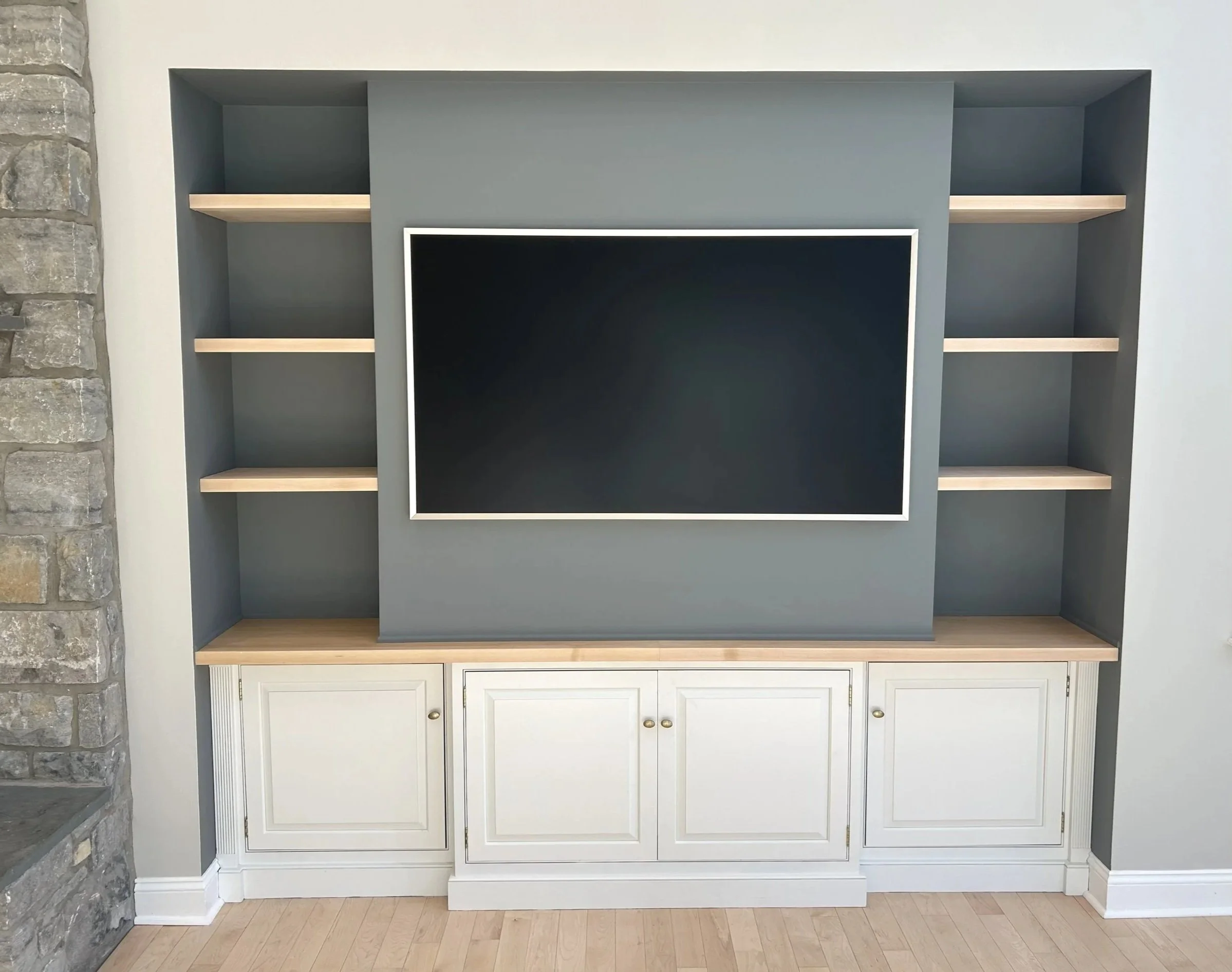 Accent entertainment unit with inset open shelving in natural wood against gray blue walls.  Designed and photographed by Sara Trotter / Chroma Maison Design.