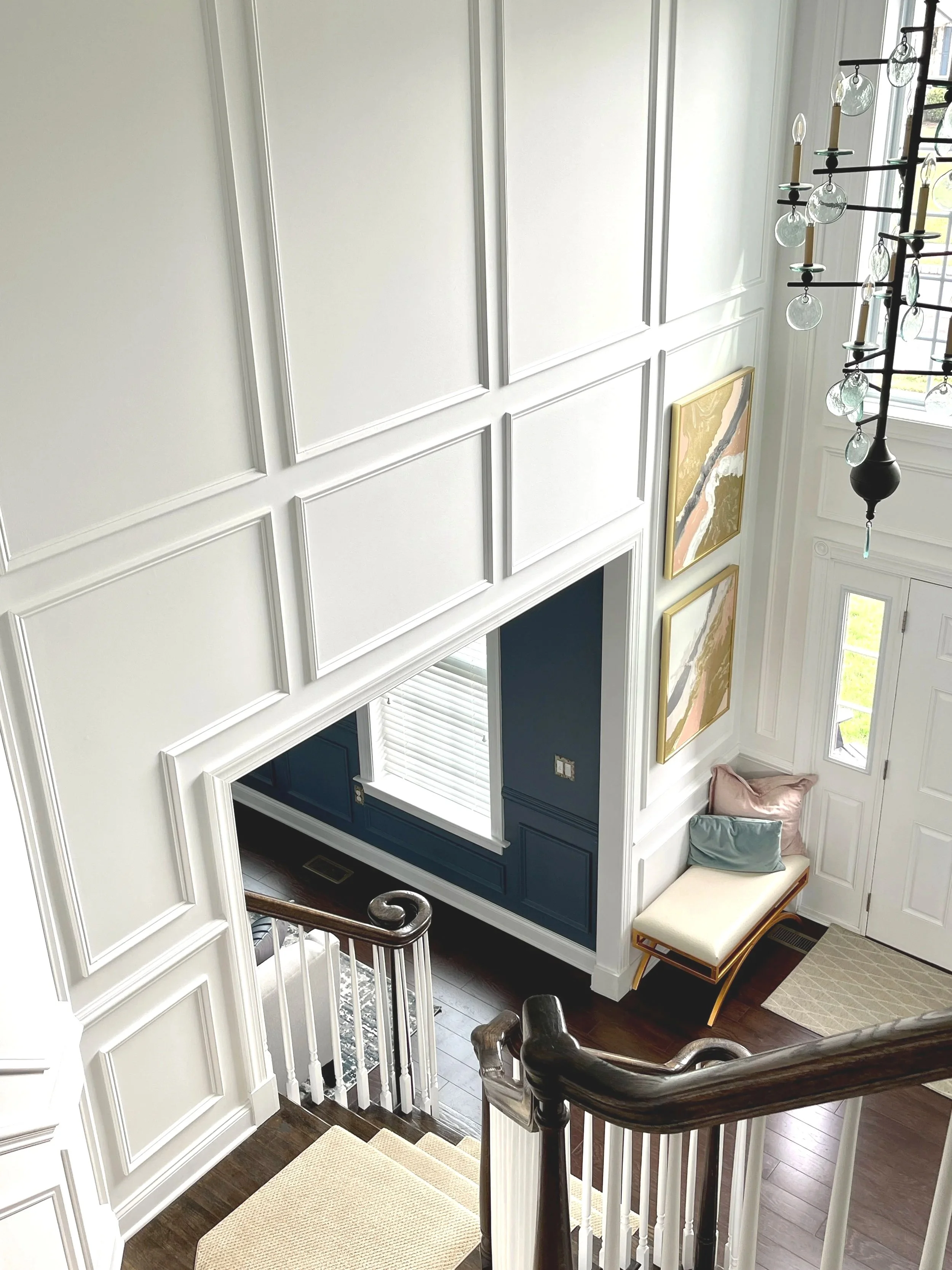 Grand two story white foyer with applied wainscoting, paint plan and photography by Sara Trotter / Chroma Maison Design.