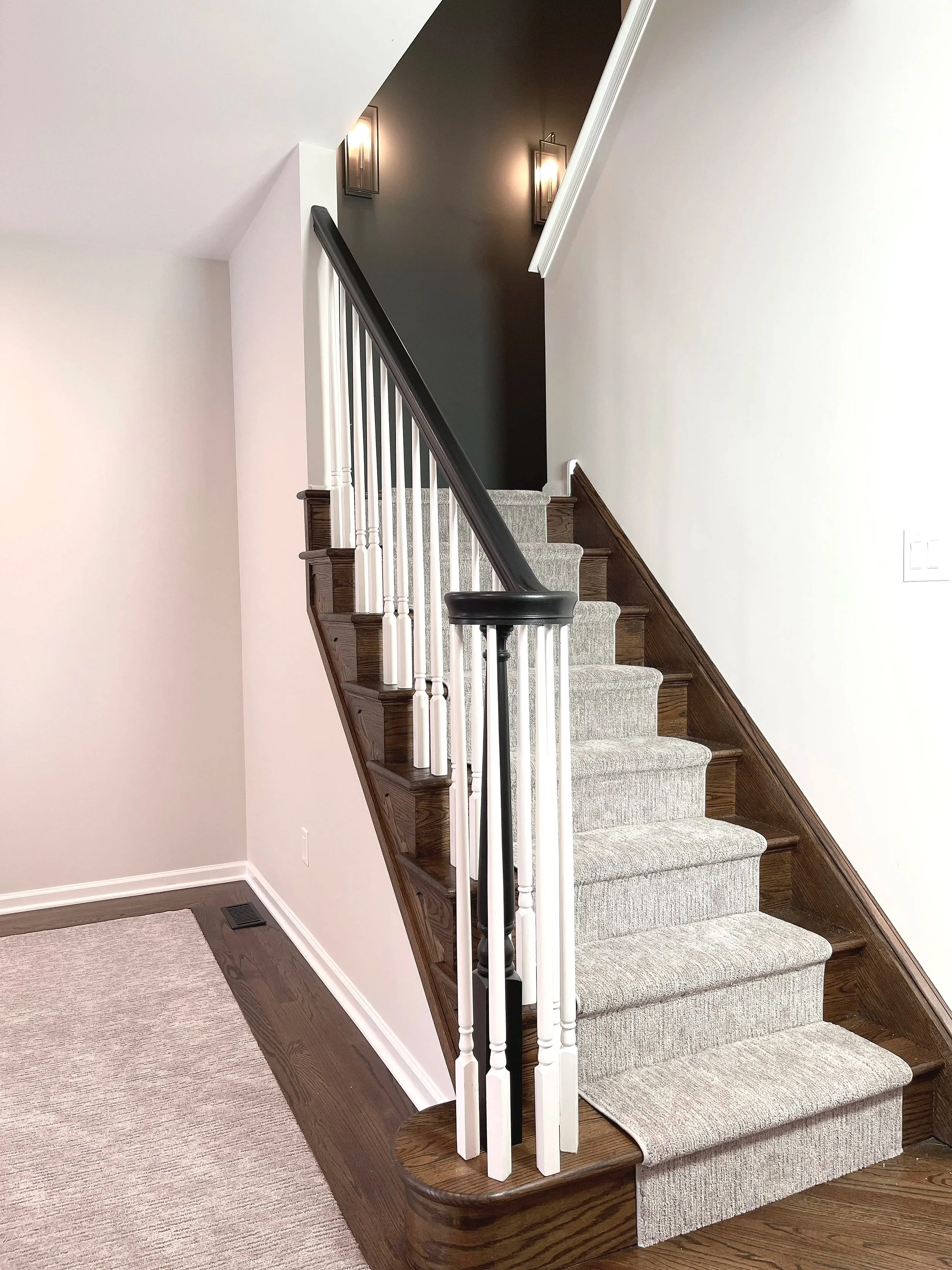 Dark Night Owl accent wall in a back stairwell for dramatic effect against the lighter surrounding walls.  Custom paint plan and photography by Sara Trotter / Chroma Maison Design.