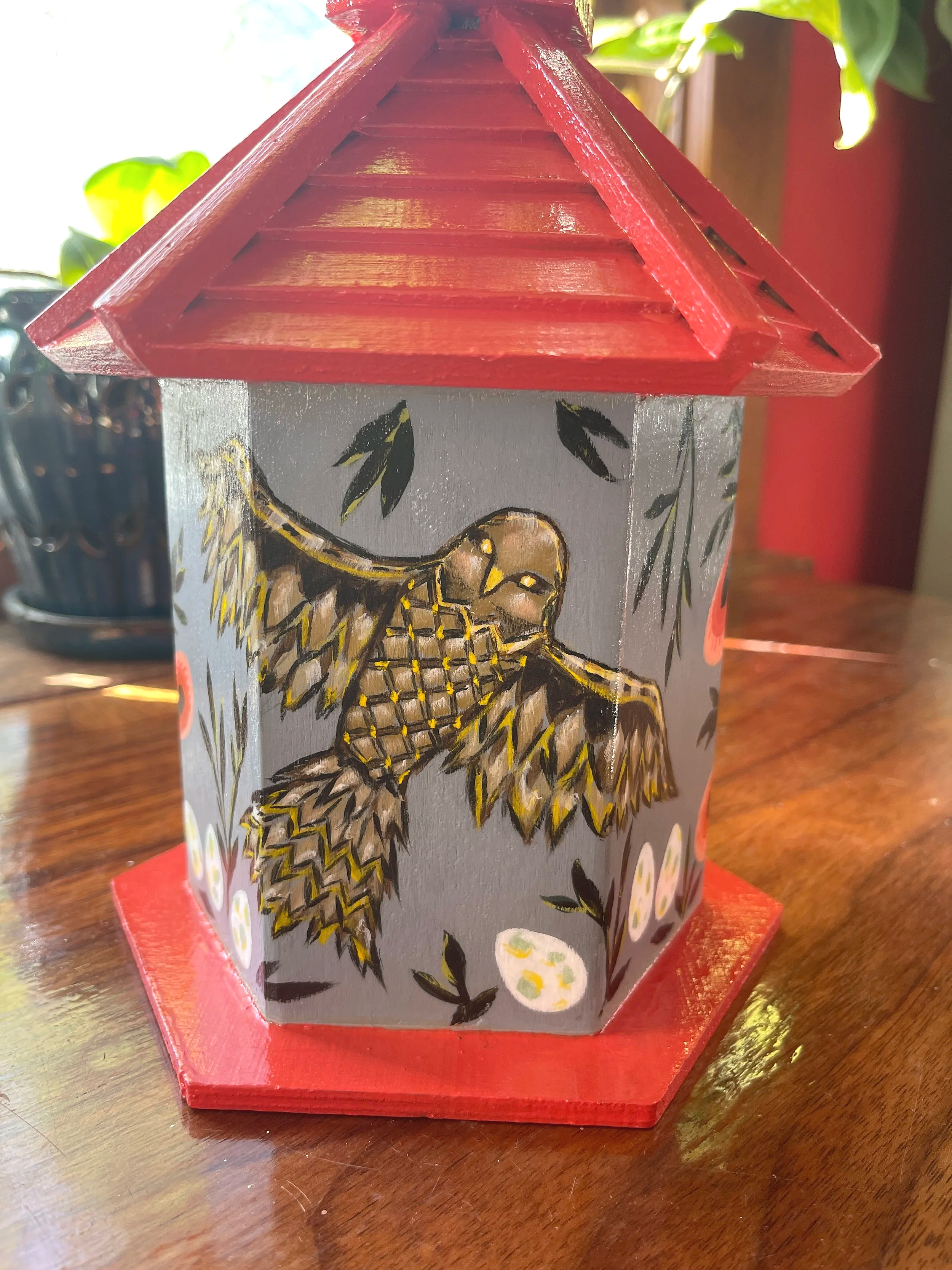 Painted wood birdhouse with red roof and owl with speckled eggs, painted by Sara Trotter.
