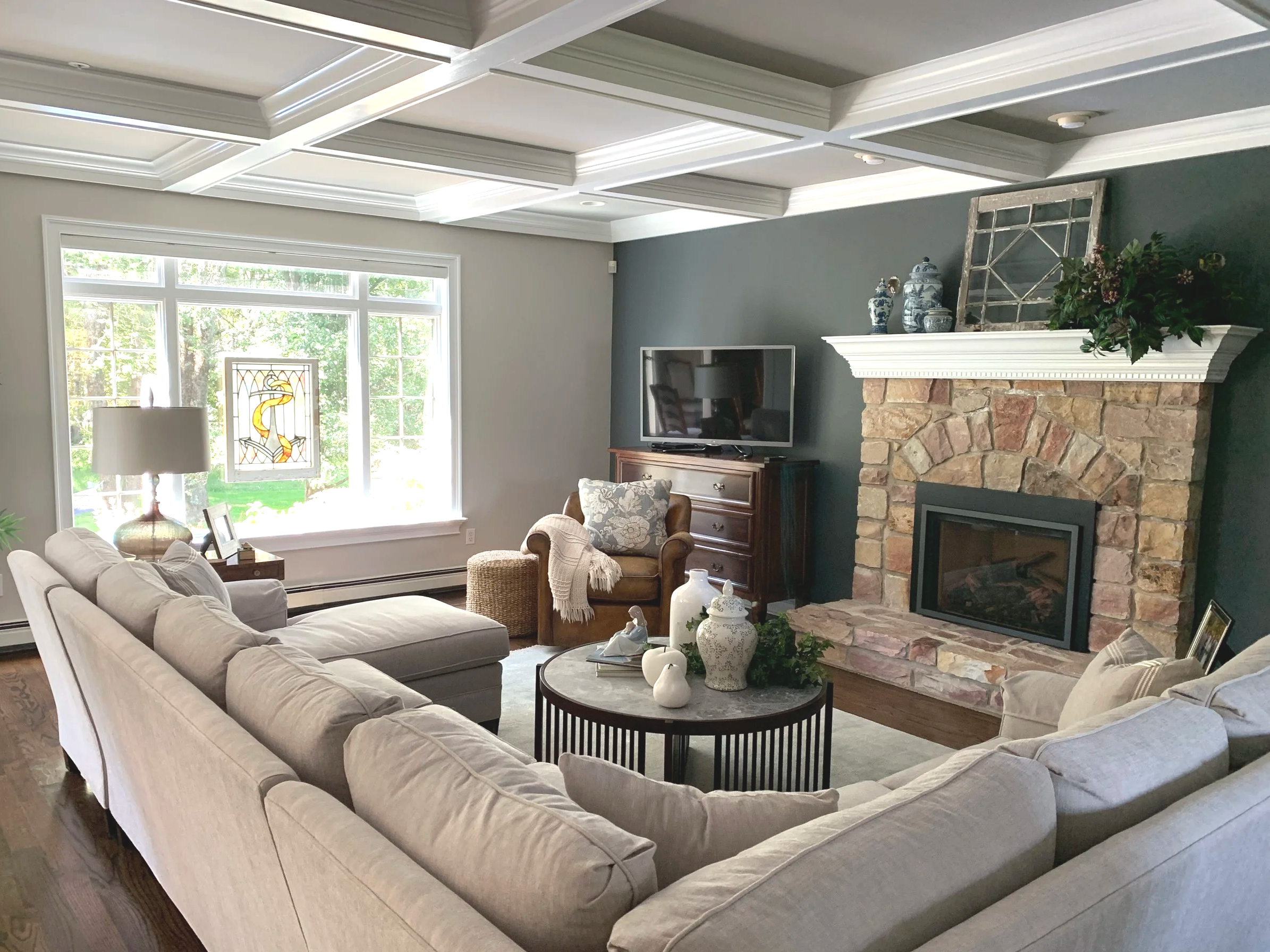 Family room showcasing a dramatic accent wall around a rustic fireplace, complete with accented recessed shadow box tray ceiling.  Custom paint plan and photography by Sara Trotter / Chroma Maison Design.
