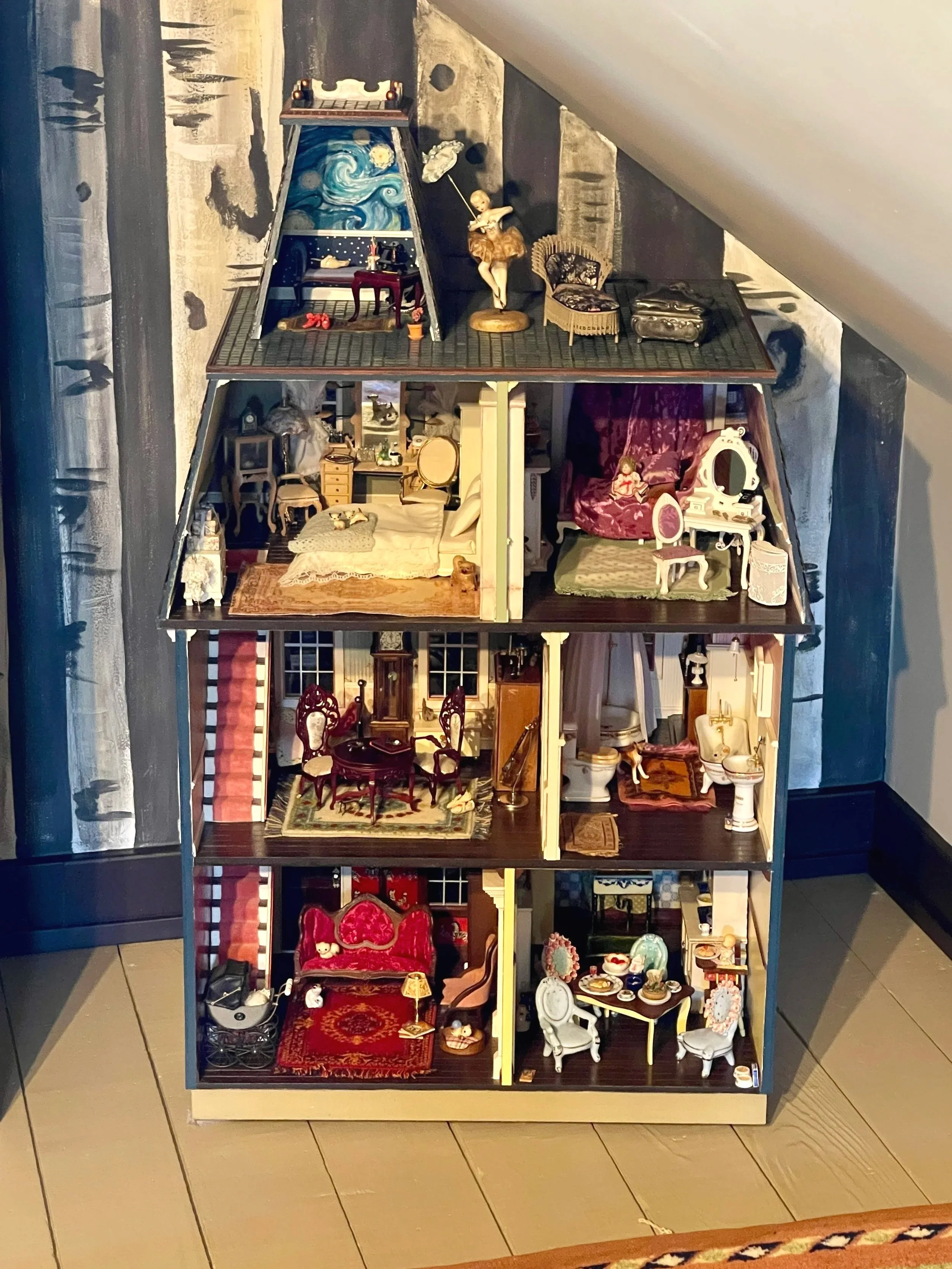 Interior view of a miniature Victorian dollhouse featuring eclectically decorated rooms and hand-painted walls, designed by Sara Trotter / Chroma Maison Design.
