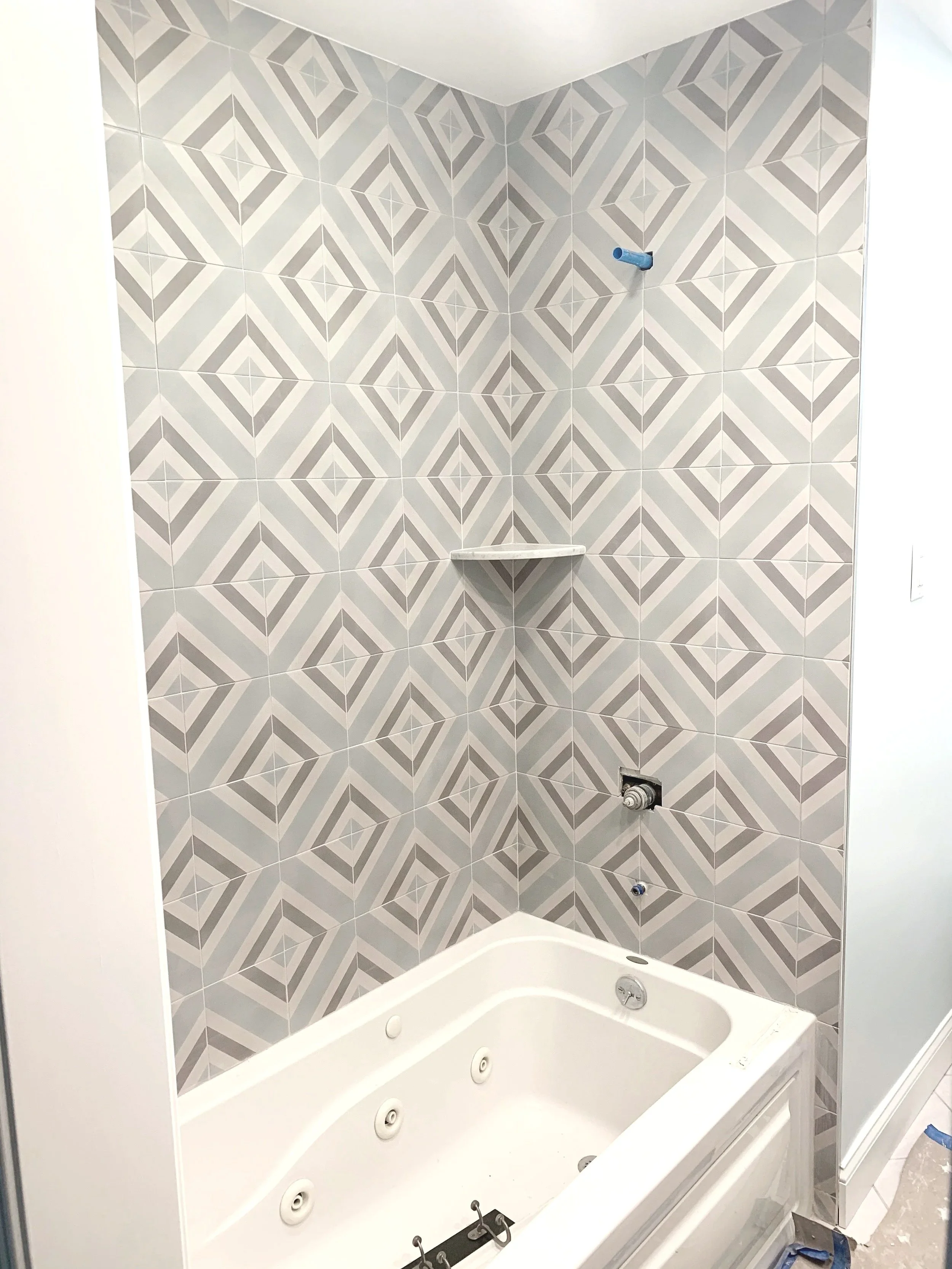 Wow aqua geometric pattern tile on tub walls for a modern playful kid's bathroom, designed and photographed by Sara Trotter / Chroma Maison Design.