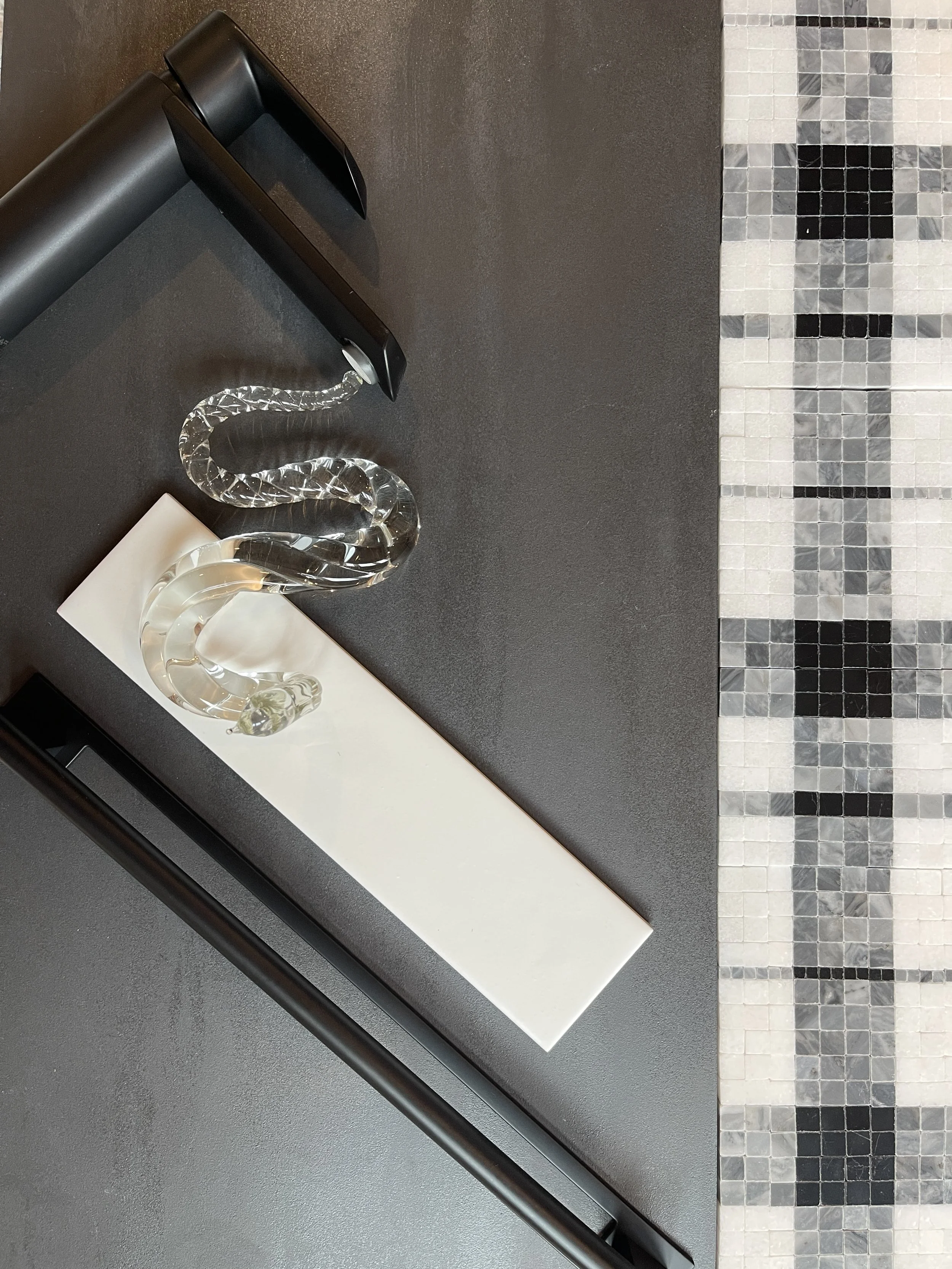Mood board with a glass water snake and plaid marble tile, made and photographed by Sara Trotter / Chroma Maison Design.