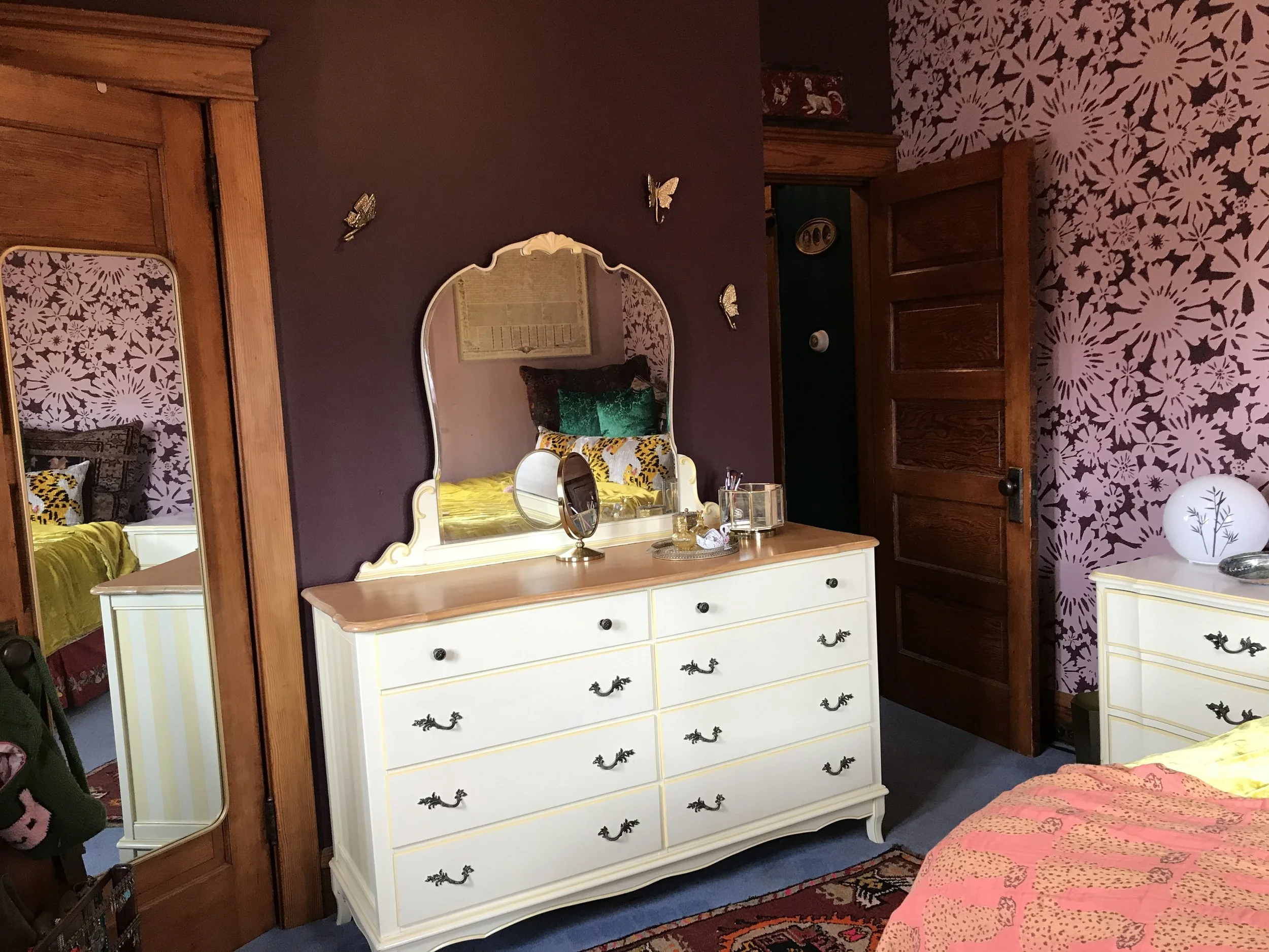 Girl's bedroom in shades of blush pink & maroon with a hand-stenciled daisy floral wall, designed and painted by Sara Trotter / Chroma Maison Design.