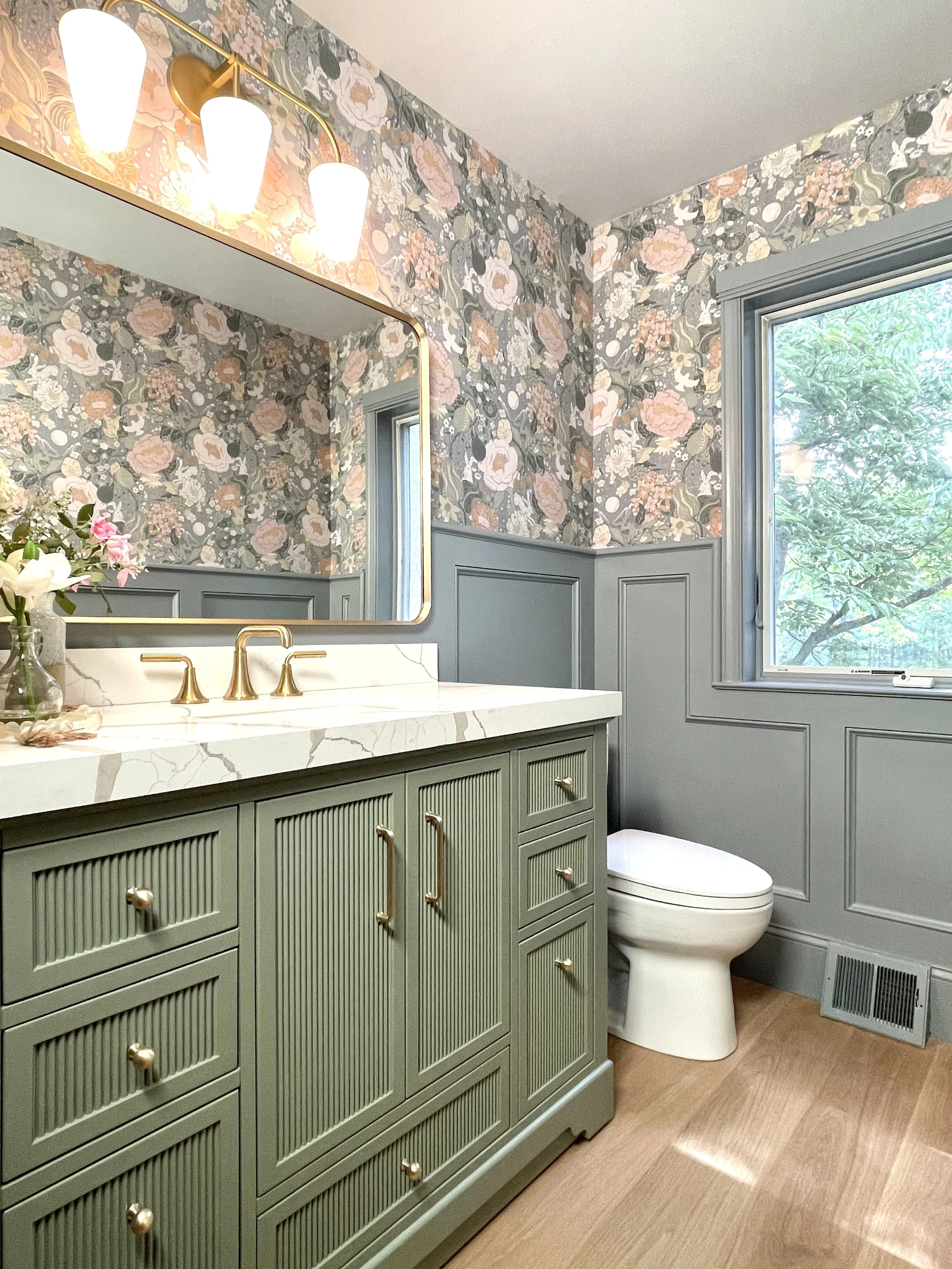 Whimsical powder room with A-Street Prints Vaxa Rabbits wallpaper above blue gray wainscoting walls, designed and photographed by Sara Trotter / Chroma Maison Design.