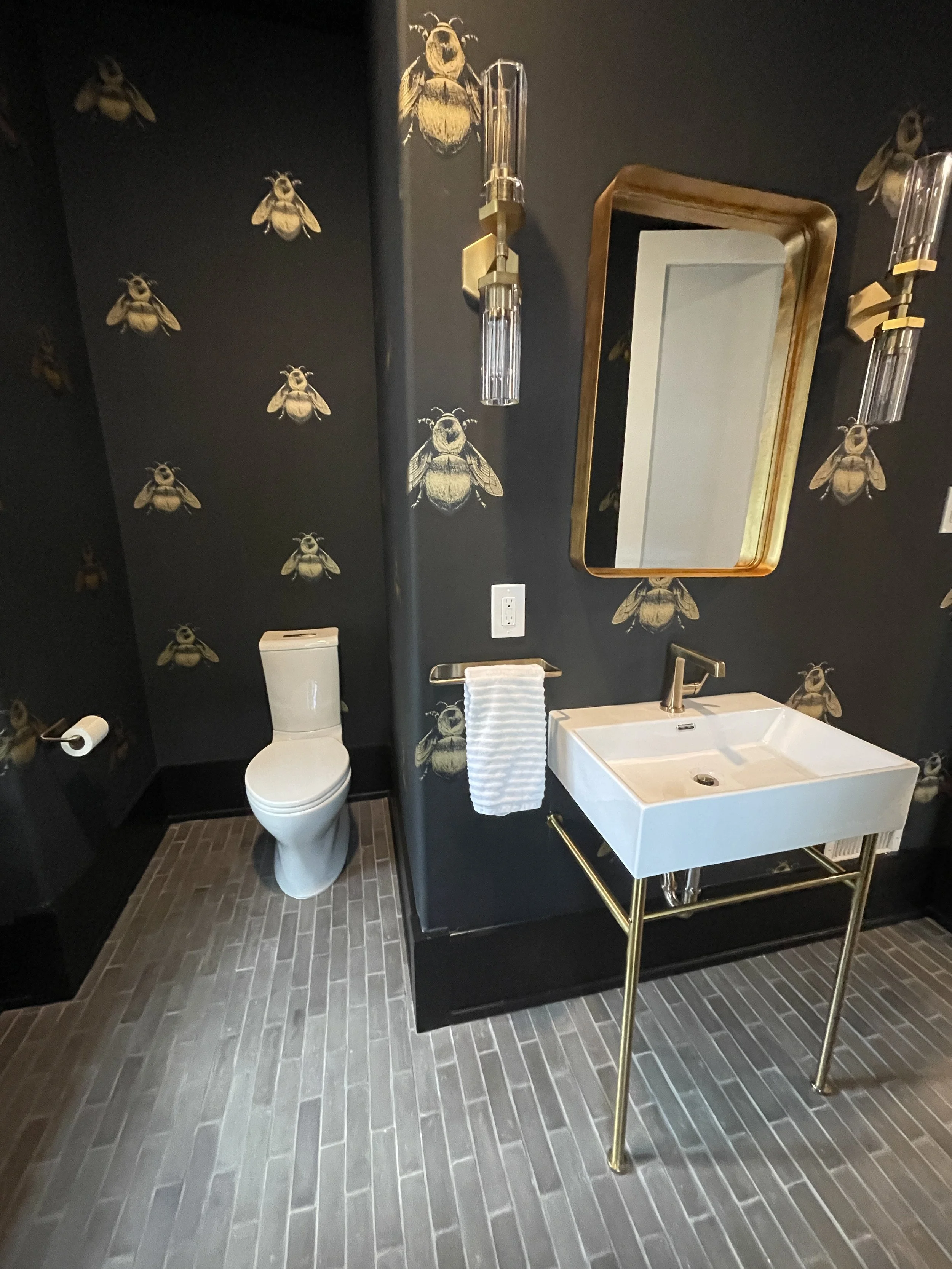 Timorous Beasties Napoleon Bee wallpapered powder room with Cle Belgian Flemish Black reproduction floor tile, designed and photographed by Sara Trotter / Chroma Maison Design.