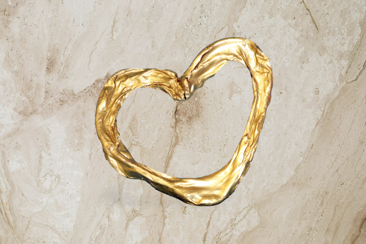 A gold heart-shaped umbilical cord keepsake