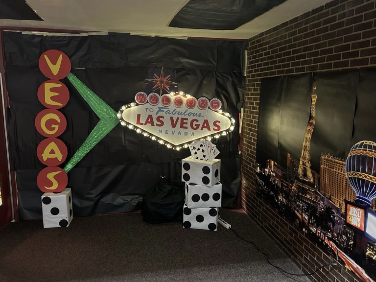 High School Homecoming Dance theme - “Vegas Night”. Decorations of dice and photos of Las Vegas, a city known for its casinos and being consumed by gambling. Promoting gambling or gambling related things in schools makes students perceive it as an “u