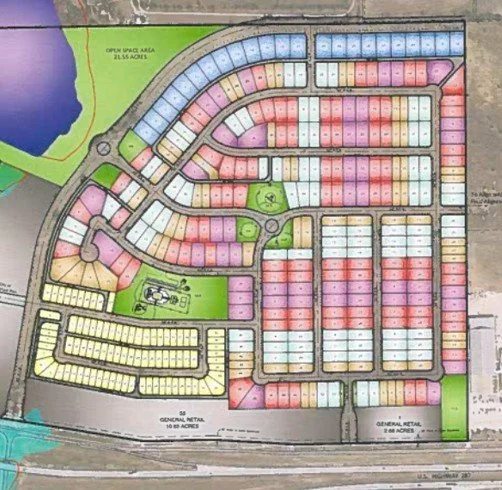 A detailed layout map of a residential development with color-coded lots, streets, parks, and water features.