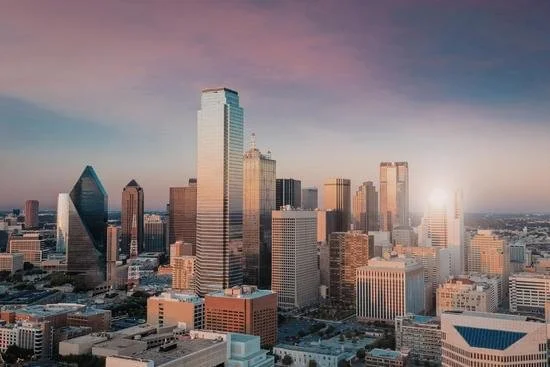 Skyline of Dallas, Texas with various tall buildings at sunset